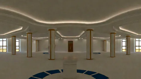 A bright white hall with columns and a pedestal at its centre.